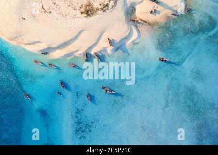 Aerial view of the fishing boats on sea coast with sandy beach Stock Photo
