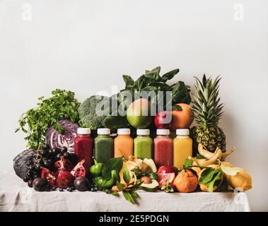 Variety of fresh colorful smoothies for detox weight loss diet. Juices in vacuum bottles with fruit, vegetables and greens ingredients, copy space. Vegan, vegetarian, clean eating, alkaline food Stock Photo