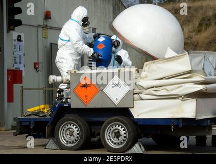Workers dressed in protective clothing, handle a dummy chemical World War Two weapon during a media demonstration at the Society for the Disposal of Chemical Weapons and Ordnance (GEKA) in Munster, March 5, 2014. The state owned GEKA is the only German company which is able to destroy chemical munitions and explosives. Syria has shipped out about a third of its chemical weapons, including mustard gas, for destruction abroad, the global chemical arms watchdog, the Organisation for the Prohibition of Chemical Weapons (OPCW) said on Tuesday. They are to be transferred to the U.S. ship MV Cape Ray