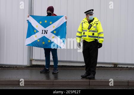 Livingston, Scotland, UK. 28 January 2021. Prime Minister Boris Johnson leaves Valneva vaccine production plant in Livingston on his visit to Scotland. The plant has commenced production of vaccines today. One man staged a solo protest against his visit.  Iain Masterton/Alamy Live News Stock Photo