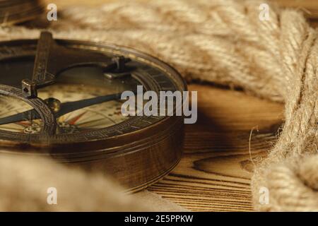 Ship rope and compass on wooden background Stock Photo