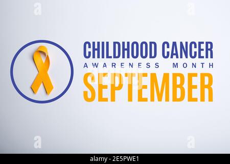 Childhood cancer awareness month. September. Yellow handmade awareness paper ribbon on white background. Stock Photo