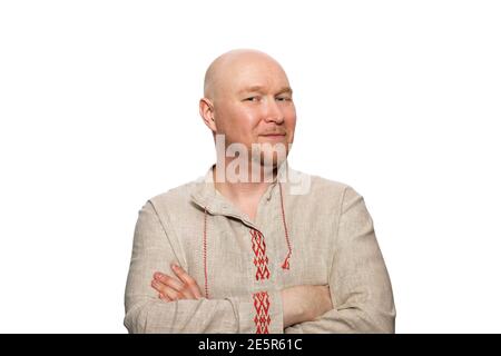A bald man in national dress crossed his arms, isolated on white background Stock Photo