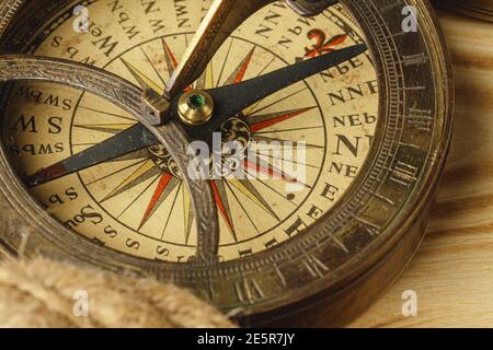Ship rope and compass on wooden background Stock Photo