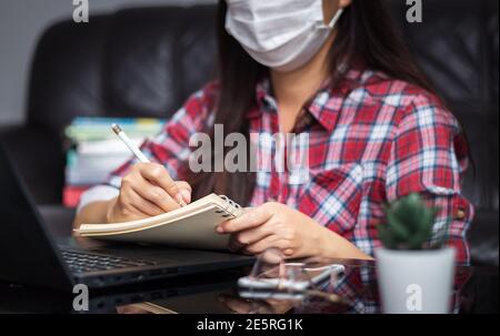 new normal, work from home, study online, homeschooling, distance education. student wear hygienic protect face mask study online listen lecture Stock Photo