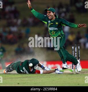 Pakistan's Umar Akmal (R) celebrates after he scored a half century as captain Misbah-ul-Haq (L) and Bangladesh's Rubel Hossain (C) watch during their second One Day International, ODI cricket match of the Pakistan's Umar Akmal (R) celebrates after he scored a half century as captain Misbah-ul-Haq (L) and Bangladesh's Rubel Hossain (C) watch during their second One Day International, ODI cricket match of the