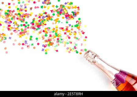 bottel of rose sparkling wine or champagne and colorful confetti on white background with copy space Stock Photo