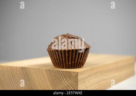 Brown chocolate muffins on wooden board Stock Photo