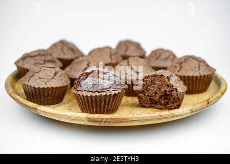 Set of homemade chocolate brown muffins on a wooden plate Stock Photo