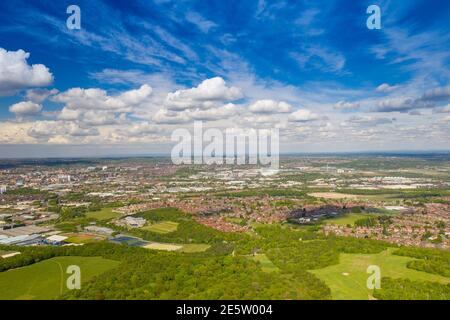 Aerial photo of the city of Leeds viewed from the village of Middleton and Middleton Park on a sunny day with white clouds in the sky and a lot of gre Stock Photo
