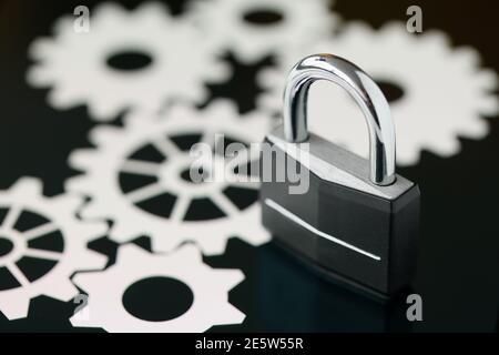 Black metal padlock standing on tablet screen closeup Stock Photo
