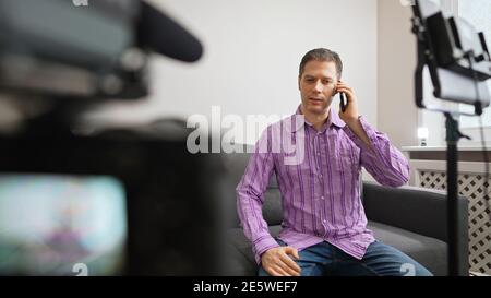 Man calling by phone from video studio. Stock Photo