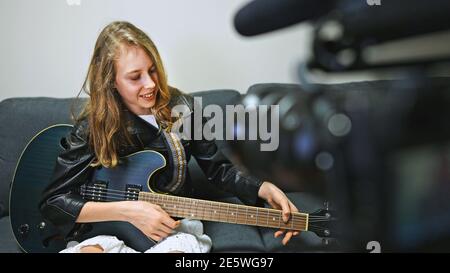 Teenage girl with semi-acoustic guitar in front of the video camera. Stock Photo