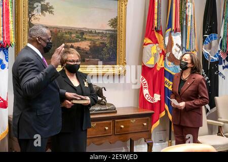 U.S. Vice President Kamala Harris, right, performs a ceremonial swearing in of Secretary of Defense Lloyd Austin as his wife Charlene Banner looks on at the White House  January 25, 2021 in Washington, DC. Stock Photo