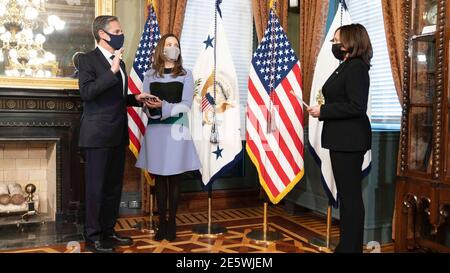 U.S. Vice President Kamala Harris, right, performs a ceremonial swearing in of Secretary of State Antony Blinken as his wife Evan Ryan looks on at the White House  January 27, 2021 in Washington, DC. Stock Photo