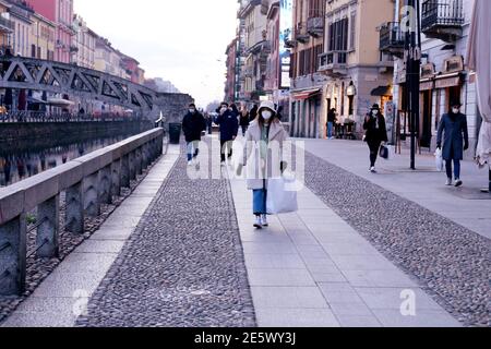 Milan, People stroll at sunset and full moon on the Naviglio Grande Editorial Usage Only Stock Photo