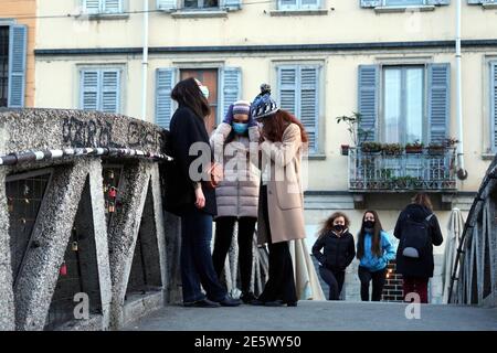 Milan, People stroll at sunset and full moon on the Naviglio Grande Editorial Usage Only Stock Photo