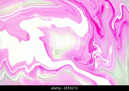 Fluid art texture. Closeup abstract pink, white and grey colors mixing of acrylic for use as background. Liquid acrylic artwork that flows and splashes with marble pattern.  Stock Photo