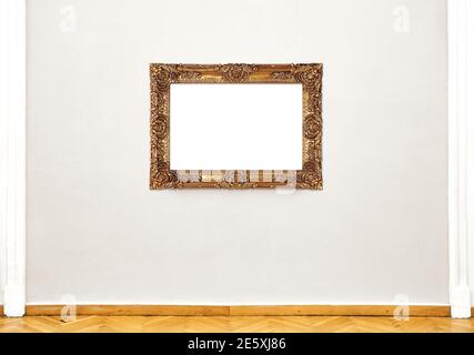 Golden empty painting frame hanging on exhibition wall, front view museum exposition Stock Photo