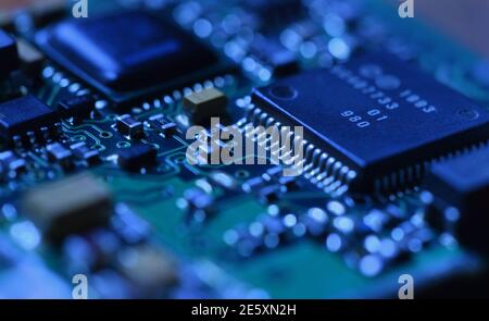 Digital microchip under dramatic blue light close-up Stock Photo