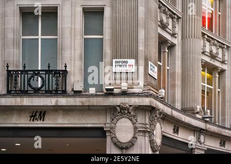 London, United Kingdom - February 01, 2019: Oxford Street W1 sign at Oxford circus crossroad, H&M stores below. This place is one of main commercial s Stock Photo