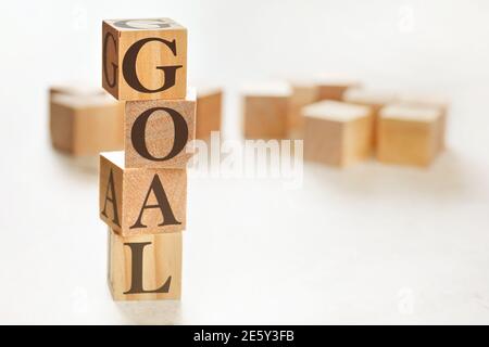 Four wooden cubes arranged in stack with word GOAL on them, space for text / image at down right corner Stock Photo
