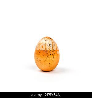 Easter egg golden color with black dots on isolated background Stock Photo
