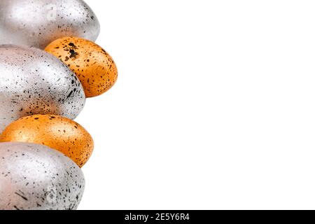 Easter eggs of gold and silver colors with black dots on an isolated background Stock Photo