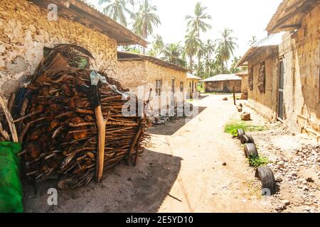 Street in an African village with a warehouse of palm leaves Stock Photo