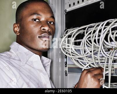 Portrait of african technician working in server room Stock Photo