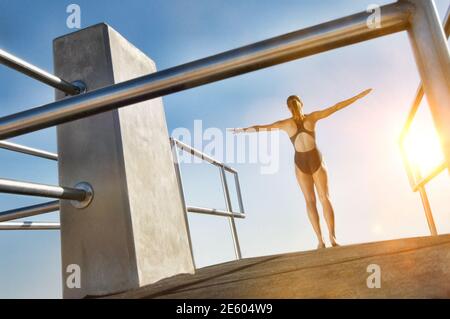 Rear view of female Diver with lens flare Stock Photo