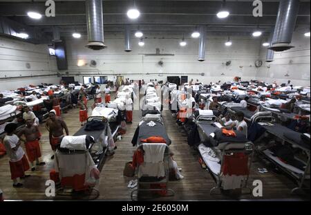 Inmates walk around a gymnasium where they are housed due to overcrowding at the California Institution for Men state prison  in Chino, California, June 3, 2011. The Supreme Court has ordered California to release more than 30,000 inmates over the next two years or take other steps to ease overcrowding in its prisons to prevent 'needless suffering and death.' California's 33 adult prisons were designed to hold about 80,000 inmates and now have about 145,000. The U.S. has more than 2 million people in state and local prisons. It has long had the highest incarceration rate in the world. REUTERS/