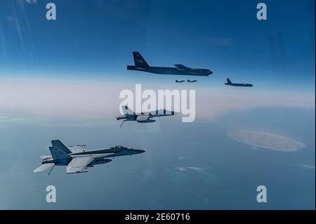 Persian Gulf, Saudi Arabia. 27th Jan, 2021. A U.S. Air Force B-52 Stratofortress strategic bomber from the 2nd Bomb Wing flies escorted by U.S. and Royal Saudi Air Force F-15 Strike Eagle fighter aircraft during a short-duration deployment to the middle east January 27, 202 over the Persian Gulf. Credit: Planetpix/Alamy Live News Stock Photo