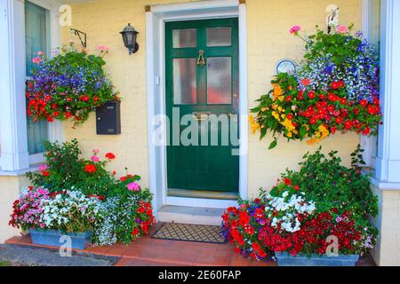 Beautifully arranged flowers in pot hanging on a nice English house facade,Deal town,Kent,UK Stock Photo