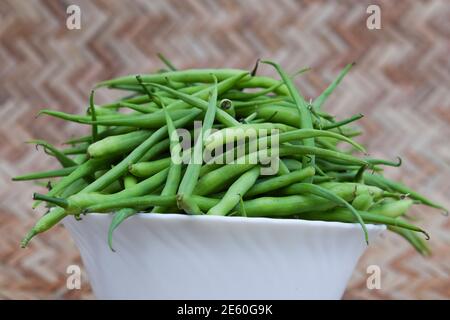 Rat tail radish pods, a green winter seasonal vegetable grown only in winters harvested and put in a bowl. Its grown mostly in Asia Asian Indian Pakis Stock Photo