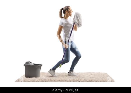 Happy young woman dancing and singing with a cleaning mop isolated on white background Stock Photo