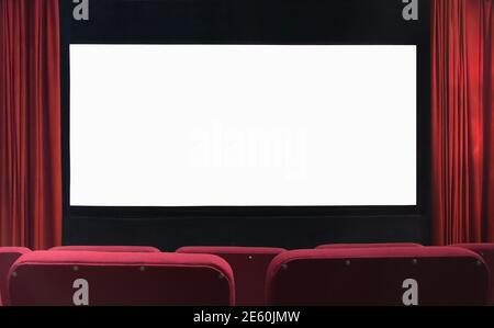 Blank movie cinema screen with red curtains and empty seats Stock Photo