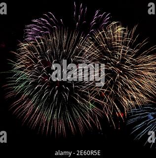 Great night colorful fireworks on black sky background in holiday Stock Photo
