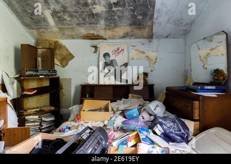 A messy bedroom inside an abandoned house with a dirty dancing poster on the wall. Ontario, Canada. Stock Photo
