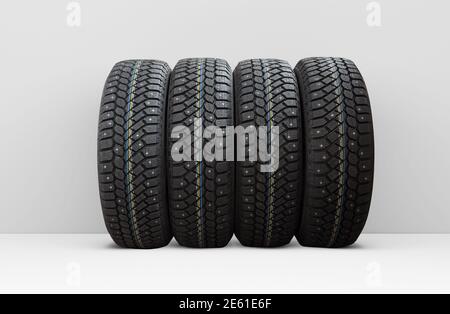 Four winter car tires with snow spikes, isolated Stock Photo