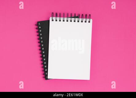Spiral notepads on a pink background, overhead view with copy space Stock Photo