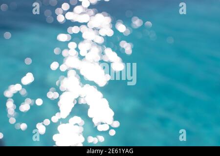 View of blurry surface of turquoise water with glare in swimming pool, sea, lake, or ocean, summer mood background. Concept rest, travel, wellness, sp Stock Photo