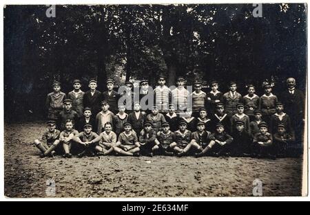GERMANY - OCTOBER 1927: The vintage photo shows the group of young boys, schoolmates. Boys wear army caps.Black and white photo. Vintage time. 1930s Stock Photo