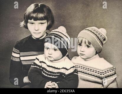 ZWICKAU, EAST GERMANY - CIRCA 1970: The retro photo shows small children-siblings. Studio portrait from the seventies last century. 1970s. Stock Photo