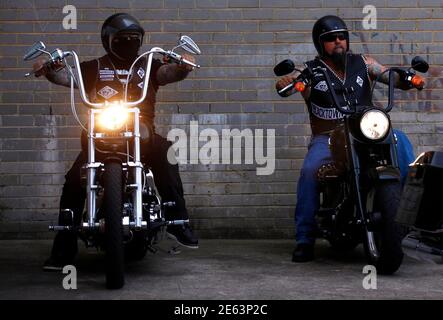 Members of the Mongols Motorcycle Club prepare to ride away from their  clubhouse compound located in western Sydney November 9, 2014. Australia is  confronting what authorities say is a growing threat from