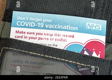 Covid-19 Vaccination or vaccine Card in wallet Stock Photo