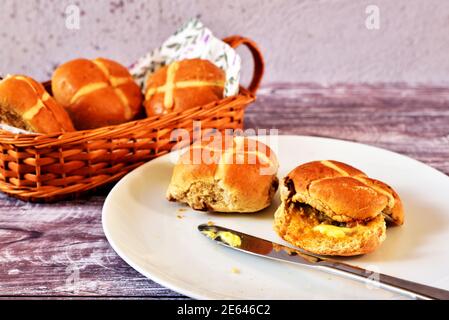 Hot Cross Buns on plate and in basket Stock Photo