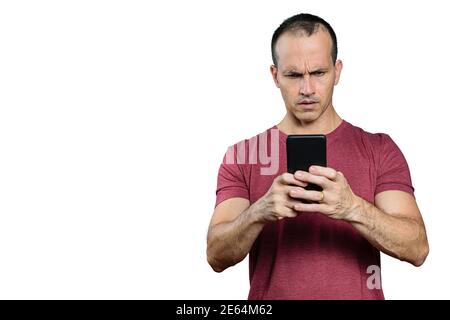 Mature Brazilian man looking at his smartphone and making a disapproving face. Stock Photo