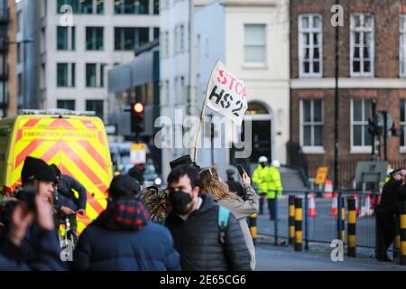 London, UK. 28 Jan 2021. HS2 Rebellion protester hold a flag marked 'Stop HS2' on Euston Square. Credit: Waldemar Sikora Stock Photo