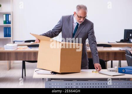 Old employee being fired from his work Stock Photo